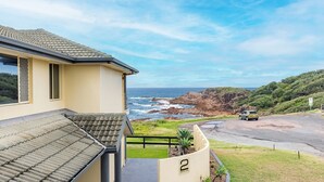 A coastal property with a view of the ocean and rocky cliffs. - Ocean View Anna Bay, 23 Ocean Avenue (Anna Bay)