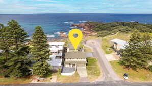An aerial view of a coastal property with a prominent yellow location marker. - Ocean View Anna Bay, 23 Ocean Avenue (Anna Bay)