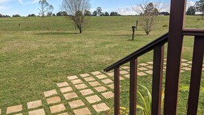 A staircase leading to a grassy area with a paved walkway.