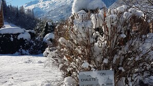 A snow-covered landscape with a sign indicating 'Chalet Le Lachat - Le Dol Menan'.