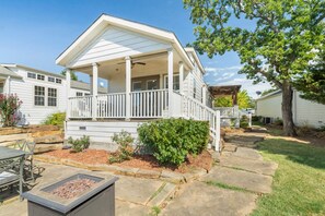 A single-story house with a covered porch, a stone pathway, and a small garden area. - Rockport at CrossTimbers Marina (Sperry)