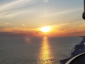 A sunset over the ocean with a clear sky and a distant shoreline. - Unique, Elegant And Beautiful 17th Floor Condo At Emerald Isle (Panama City Beach)