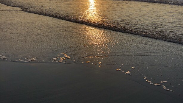 A beach scene with the sun reflecting on the water at sunset. - Charming Beach block getaway! Leave your sheets, towels at home! You're on VACA! (Brigantine)