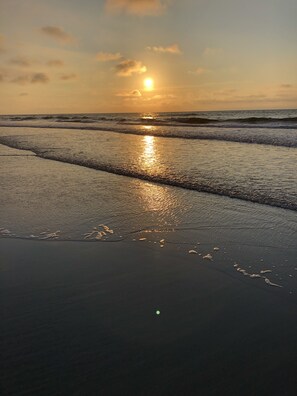 A beach scene with the sun reflecting on the water at sunset. - Charming Beach block getaway! Leave your sheets, towels at home! You're on VACA! (Brigantine)