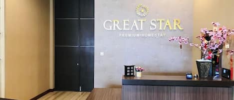 A reception desk with a sign that reads "GREAT STAR PREMIUM-HOMESTAY".