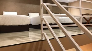 A bedroom with two beds, a glass partition, and a staircase. - Great Star Premium Homestay (Malang)