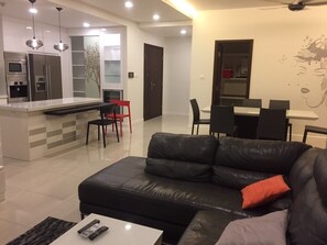 Relax in this stylish living space with a comfortable sofa, coffee table, and dining area.