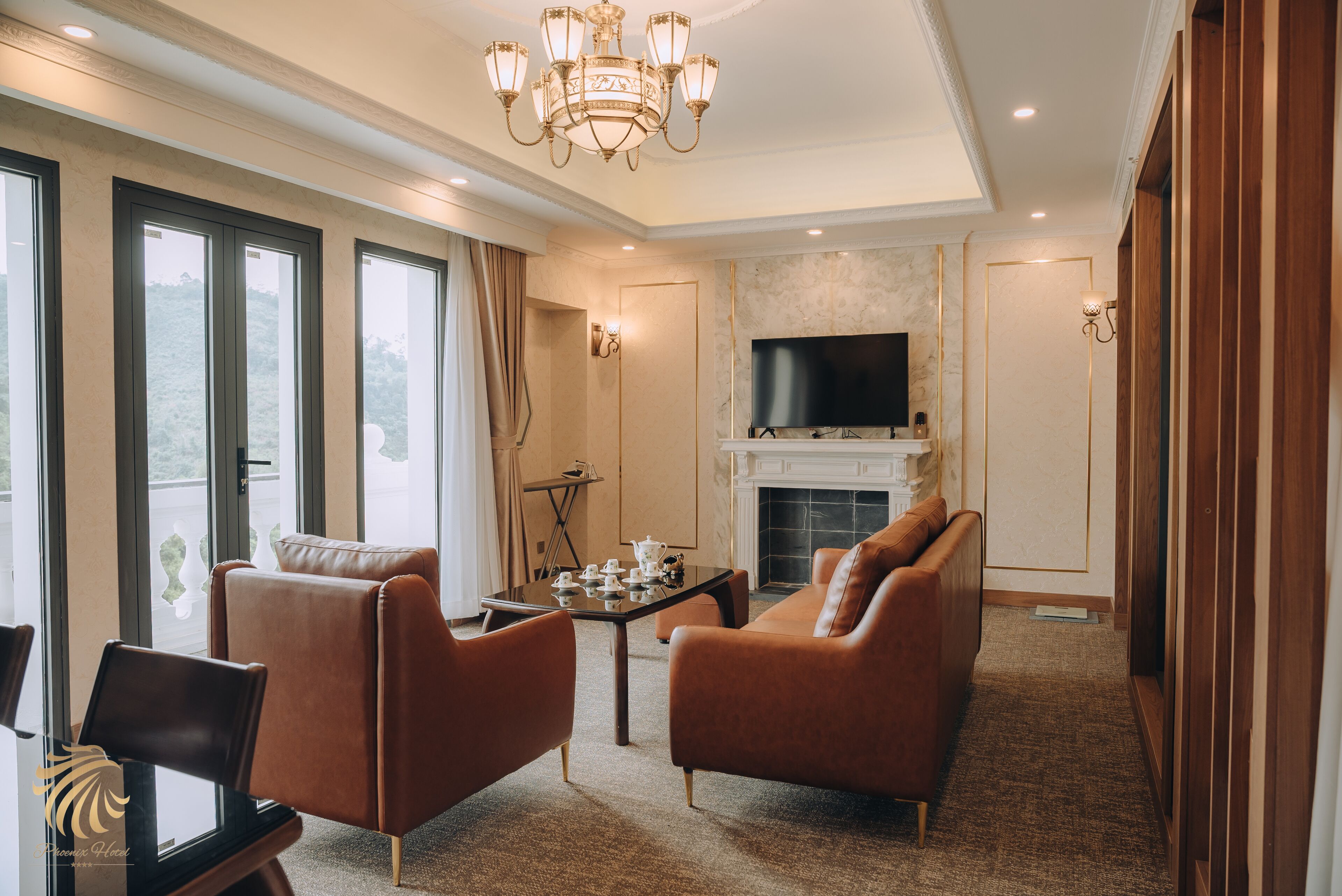 A living room with leather sofas, a coffee table, a fireplace, and a TV.