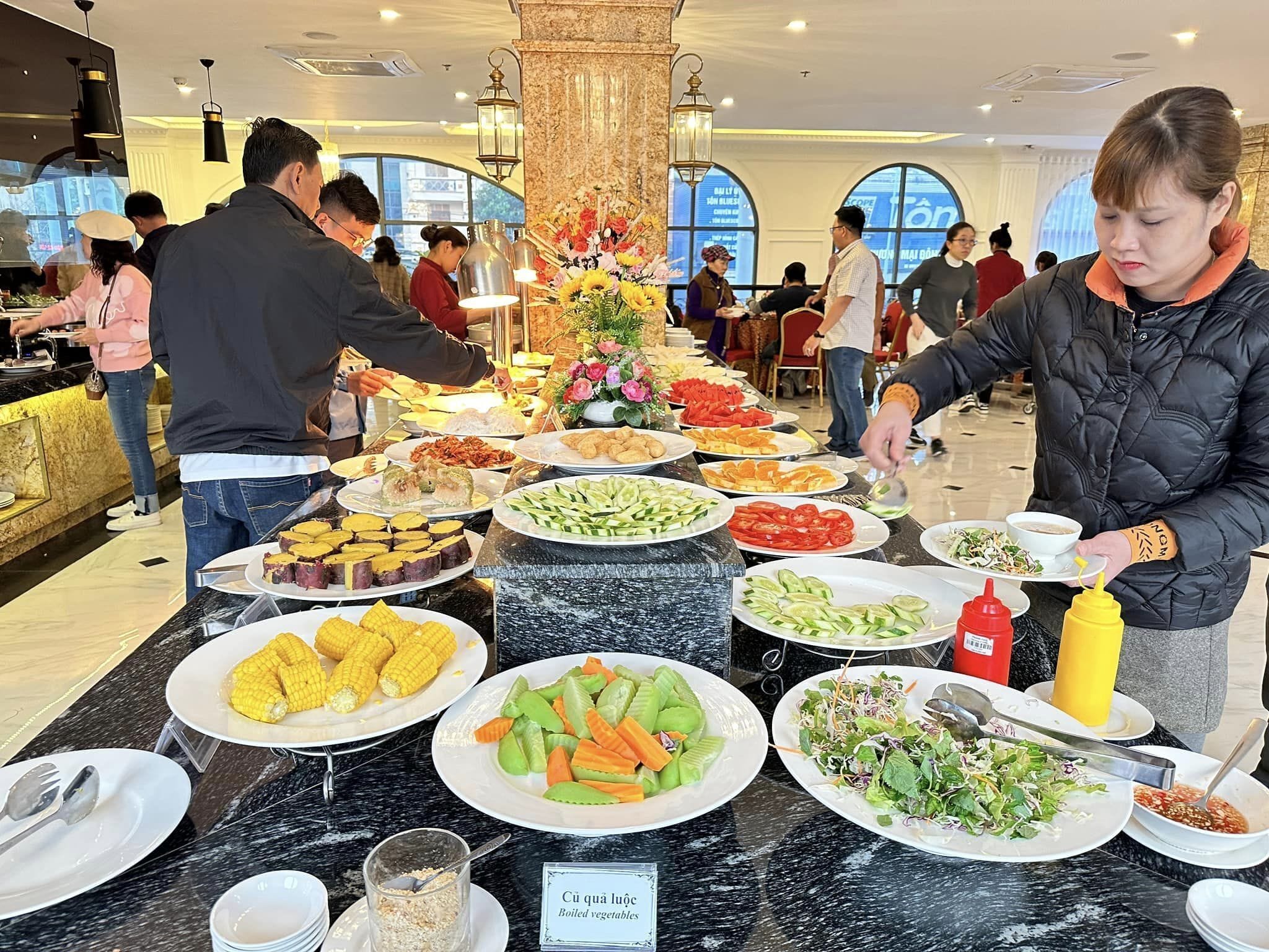A buffet with various dishes including corn, vegetables, and salads.
