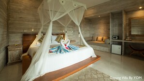 Een moderne slaapkamer met een hemelbed, houten wanden, een klein bureau en een bank.