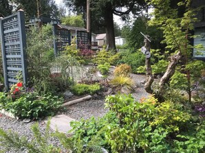 Stroll through the serene garden, surrounded by lush plants and trees.