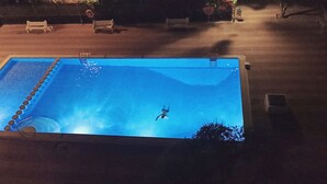 A rectangular swimming pool with a ladder on one side, surrounded by a wooden deck. - CALAFELL 5 BEACH WITH: POOL, BEACH, PARKING, SUPERMARKETS / MAC-DONALS (Calafell)