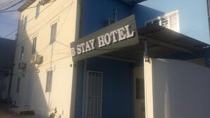 A building with a sign that reads "B STAY HOTEL".