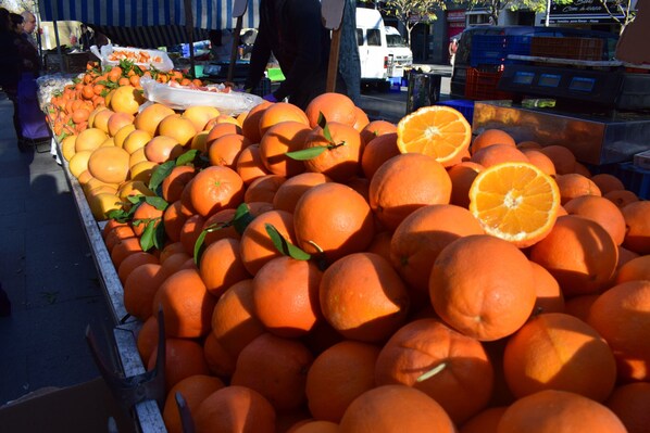 A display of oranges at a market stall.