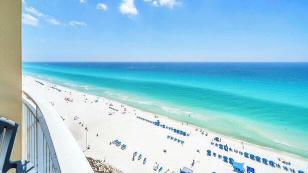 A beach with clear turquoise water, white sand, and blue umbrellas. - ☀️BeachFRONT-2 Gulf Front Pools-Aqua Resort 1505☀️ (Panama City Beach)