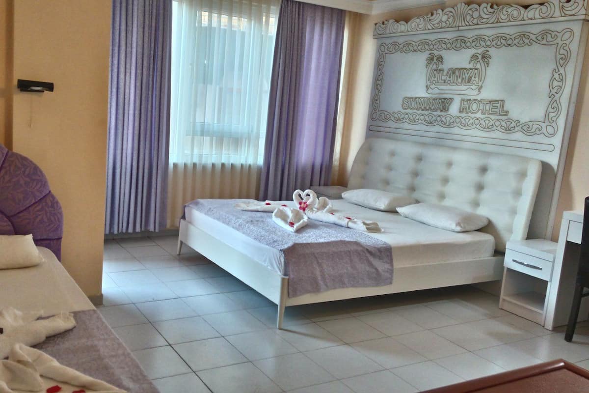 Triple Room | Minibar, in-room safe, desk, iron/ironing board
