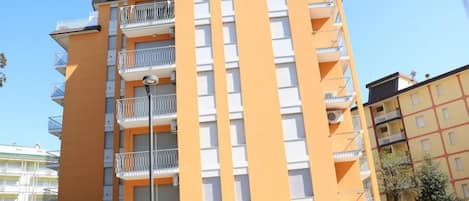 A multi-story building with balconies, likely an apartment complex.