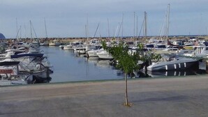 A marina with numerous boats docked in calm waters.