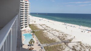 A resort with a pool, beach, and ocean view. - Beach Front Condo, Spacious, Clean and Comfortable (Gulf Shores)