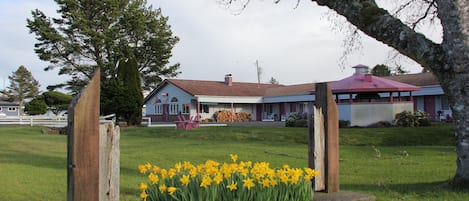 A building with a red roof and a covered porch.
