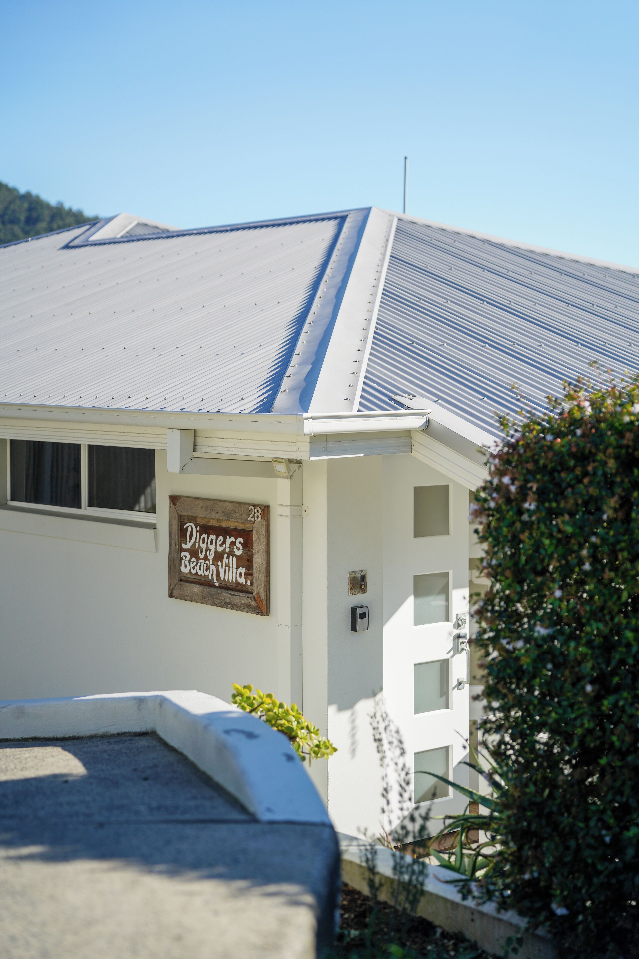 A building with a sign reading "Diggers Beach Villa."