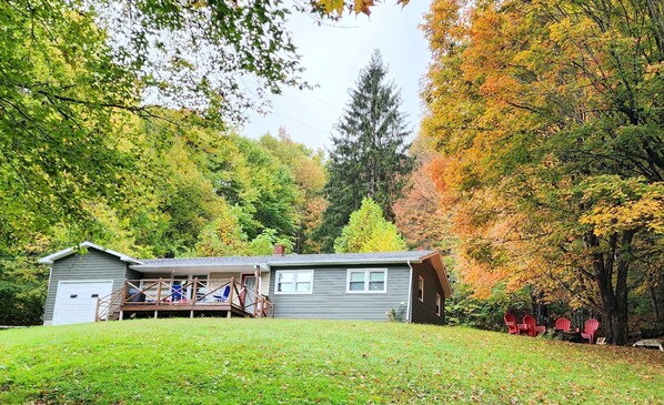 A two-story house with a covered porch and a garage.