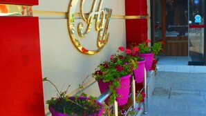 A hotel sign with the name "HOTEL ÜLKE" and a large golden "H" logo. - Hotel Ülke (Yalova)