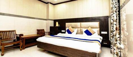 A bedroom with a large bed, wooden furniture, and a modern design.