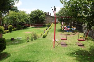 A playground with swings and a climbing structure.