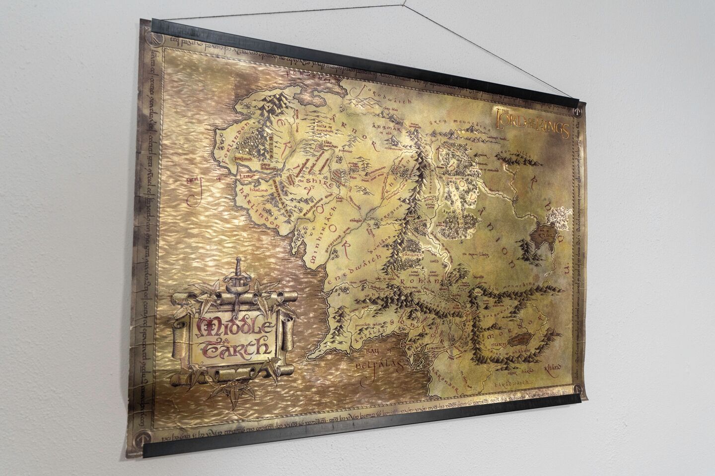 A framed map of Middle Earth with a prominent "Middle Earth" label.
