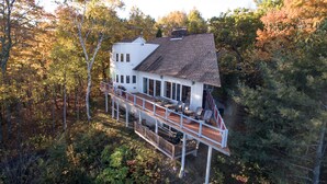 A two-story house with a deck and a covered outdoor area. - Spacious Mtn Top Contemporary - Spectacular Views - in Waterville Estates (Campton)