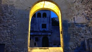 An arched stone doorway leading to a building labeled "TAVERN DE L'ABAT." - The only one with a pool in downtown Tossa. Beach 100 m away, sleeps 6, Wi-Fi, renovated (Tossa de Mar)