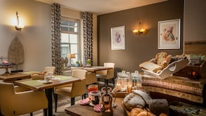 A cozy dining area with a table set for breakfast, featuring bread, pastries, and a coffee pot. - Bergkristal, premium apartment located in Epen - South Limburg. (Epen)