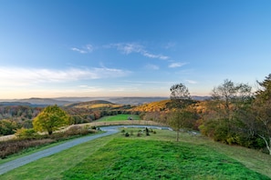 A scenic landscape with rolling hills, a river, and a clear sky. - Highland Mist  Pet Friendly, Beautiful Views, Hot Tub, Game Tables, Winery Close by (Banner Elk)