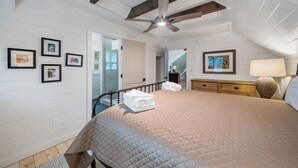 A bedroom with a bed, a ceiling fan, a nightstand, a lamp, and framed pictures on the wall. - Highland Mist  Pet Friendly, Beautiful Views, Hot Tub, Game Tables, Winery Close by (Banner Elk)