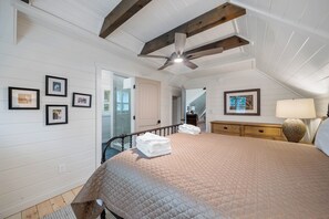 A bedroom with a bed, a ceiling fan, a nightstand, a lamp, and framed pictures on the wall. - Highland Mist  Pet Friendly, Beautiful Views, Hot Tub, Game Tables, Winery Close by (Banner Elk)