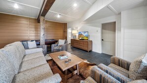 A spacious living room with a pool table, comfortable seating, a coffee table, and a television. - Highland Mist  Pet Friendly, Beautiful Views, Hot Tub, Game Tables, Winery Close by (Banner Elk)