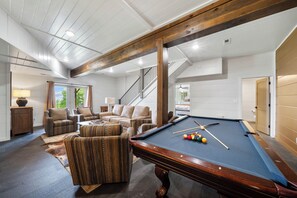 A spacious living room with a pool table, comfortable seating, and a staircase leading to an upper level. - Highland Mist  Pet Friendly, Beautiful Views, Hot Tub, Game Tables, Winery Close by (Banner Elk)