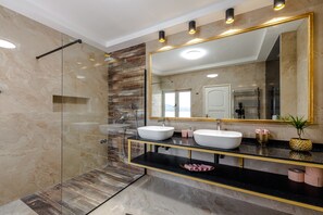 A modern bathroom with two sinks, a glass-enclosed shower, and a large mirror with a gold frame. - Villa Ragusea with Heating Pool and Private Beach (Slano)