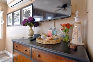 Cozy retreat with a flat-screen TV, dresser, and comfortable seating area.