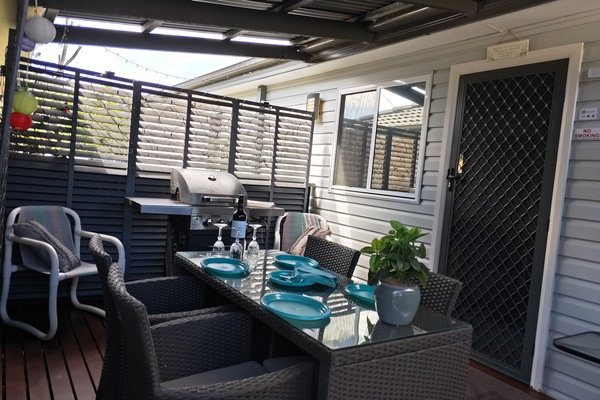Deck with bbq and outside setting with fairy lights