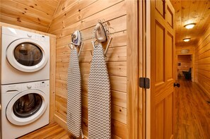 A laundry room with two washing machines and ironing boards. - Gatliburg Mansion | Best Views In The Smokies | 14 Full Suites (Gatlinburg)