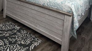 A bedroom with a wooden bed, a nightstand, a dresser, a ceiling fan, and a rug. - Beautiful Gulf Front Complex,White Sandy Beaches, private pool, Paradise Awaits! (Navarre)