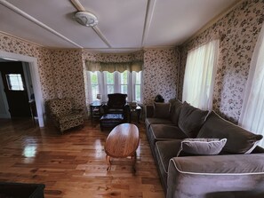 Relax in this traditional living room with a leather sofa, patterned armchair, and wooden coffee table.