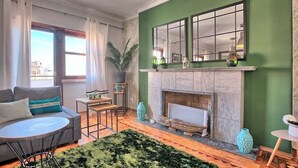 A living room with a fireplace, green walls, a sofa, and a coffee table. - APOLONIA 4 FRONTAL. In the center of the monumental Lisbon  (Lisboa)