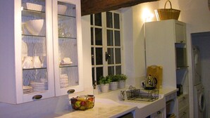A kitchen with white cabinets, a window, a sink, and a kettle. - Three Levels -2 Bedroom-2 Bathroom-alfresco Terrace-fully Renovated (Saignon)