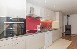Fridge, stovetop, dishwasher, coffee/tea maker