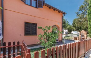 Stroll through the charming entrance to this inviting home, featuring a covered porch and beautifully landscaped surroundings.