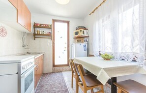 Enjoy meals at the dining table near a window with a view of the outdoors.