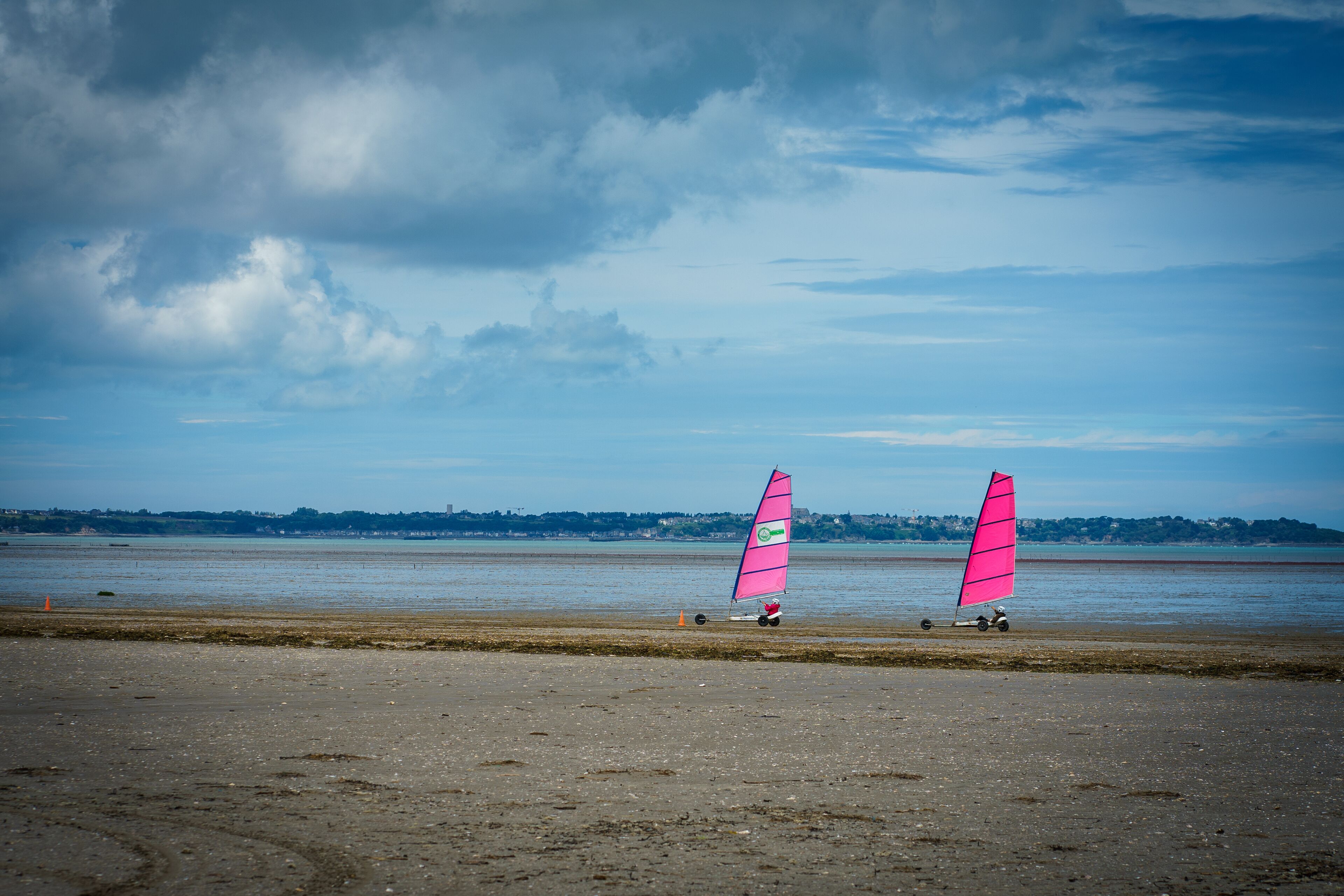 A beach with two windsurfing boards and a clear sky.